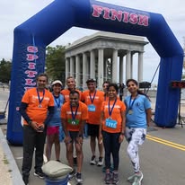 Team at finish line arch