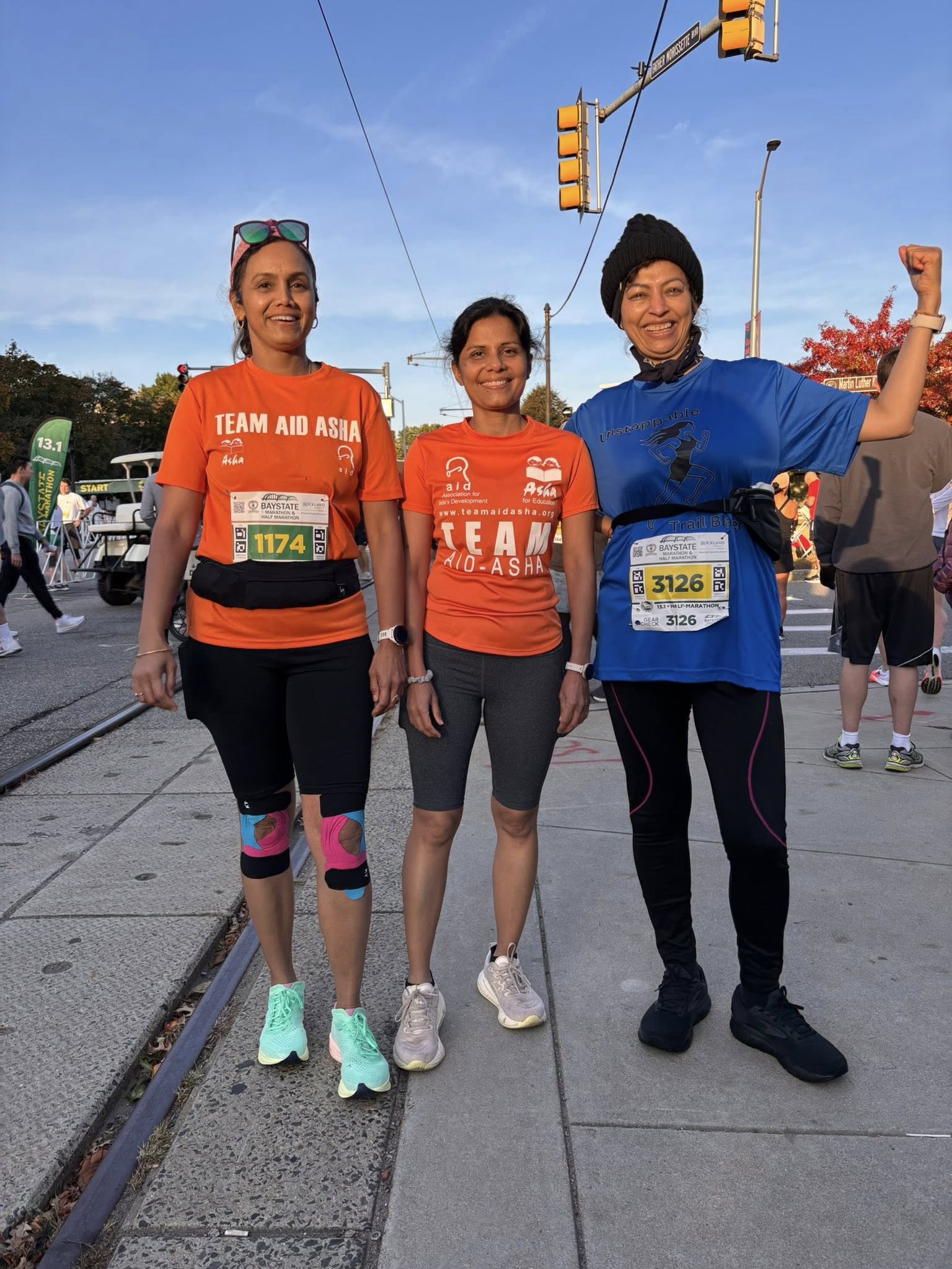 Two women with thumbs up and medals indoors