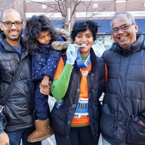 Large team group with medals and orange shirts